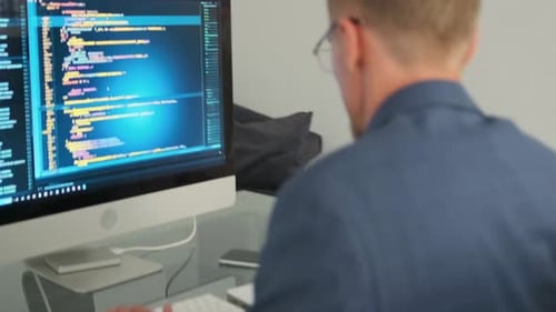 Man Coding and Drinking Coffee at Computer