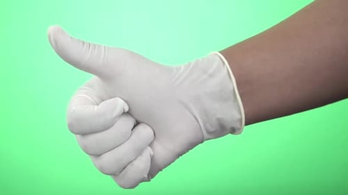 Close-up shot of left and right hands of a woman alternating in frame wearing white latex gloves and