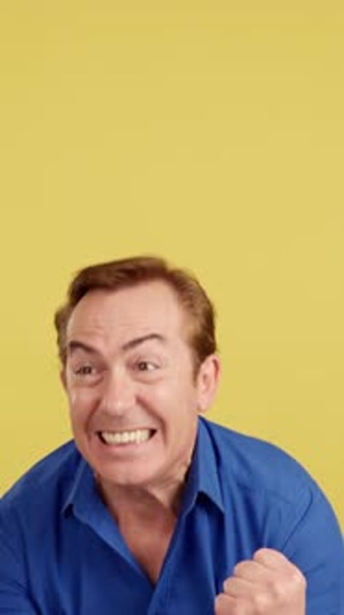 Excited Adult Man Celebrates Against Yellow Background