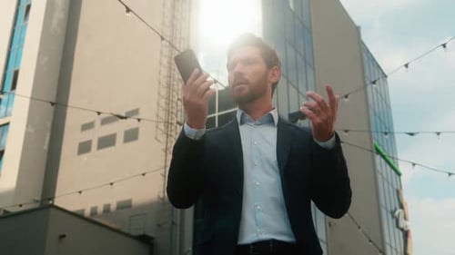 Frustrated Businessman Arguing on Phone in Urban Setting