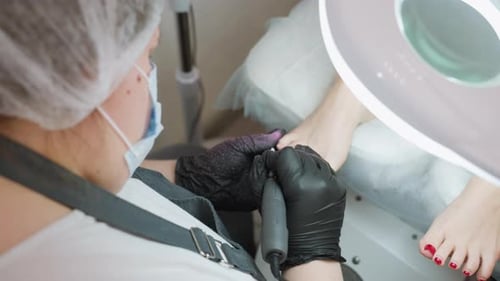 Technician Filing Toenails at Pedicure Appointment
