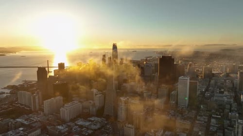 Stunning golden dawn sunlight cast over San Francisco cityscape with clouds