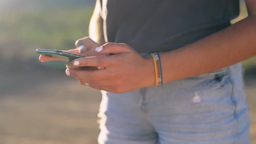 Phone, chat and hands of woman in countryside with social media or texting closeup