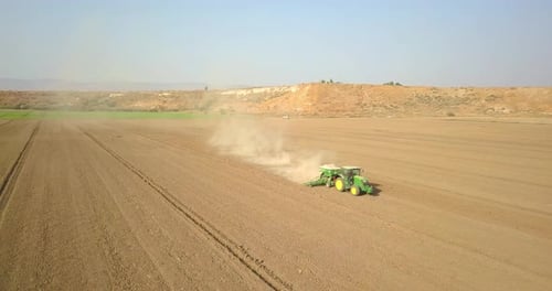 Tractor Planting Crops in Rural Field Aerial View