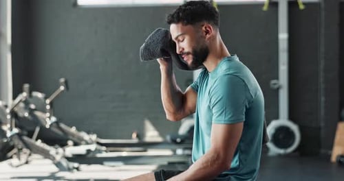 Man, smartphone and towel in gym or fitness with relax, sweating and exercise break with happiness