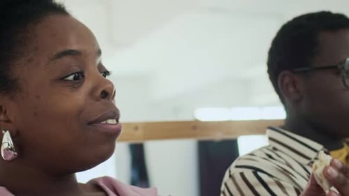 Colleagues Having Conversation during Office Lunch Break in Lounge
