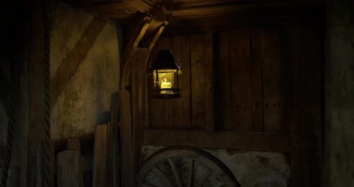 Rustic Candle Lantern Flickering Light in Old Barn