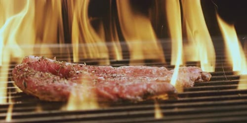 Bone steak cooking on grill