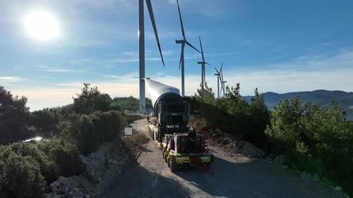 Aerial View Of Wind Turbine Blade Being Moved Through Mountains