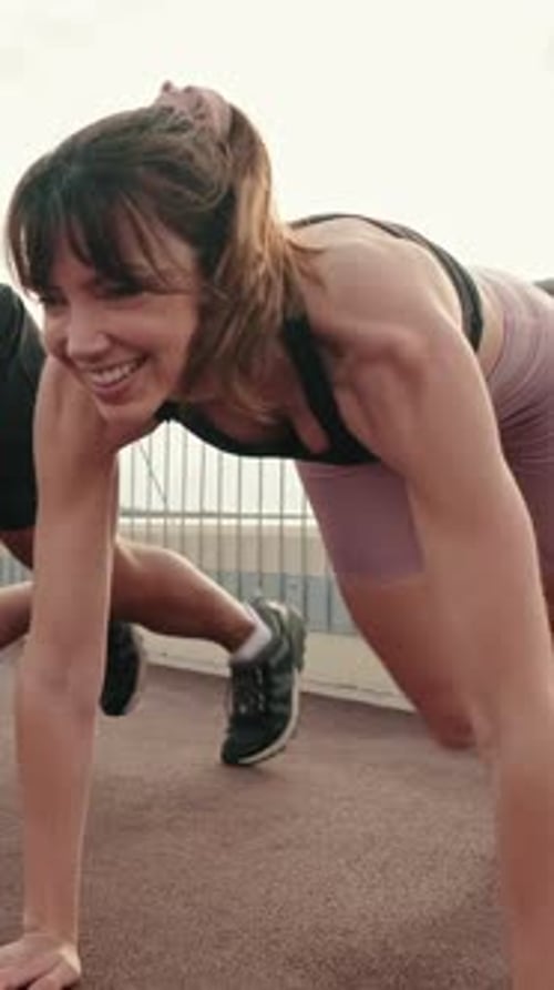 Close-up of happy multi-ethnic couple training outdoors, doing crossfit outside