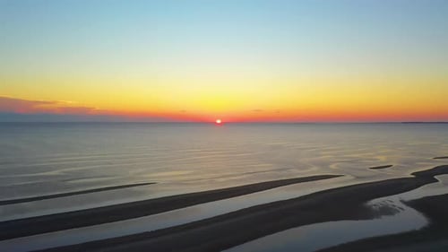 Beautiful Cape Cod Bay Sun Set Aerial Drone Footage of Sun Touching Ocean Horizon, Sand Bars, Puddle