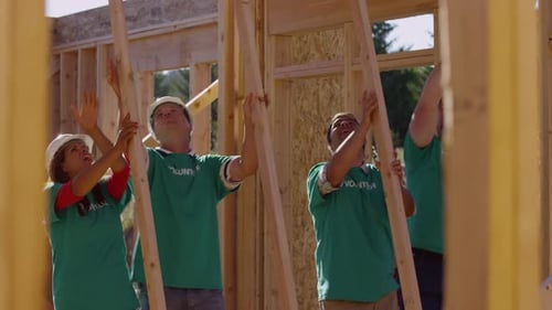Volunteers Raising Wood Frame for New Building