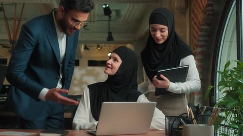 Colleagues Collaborate on Project at Modern Office