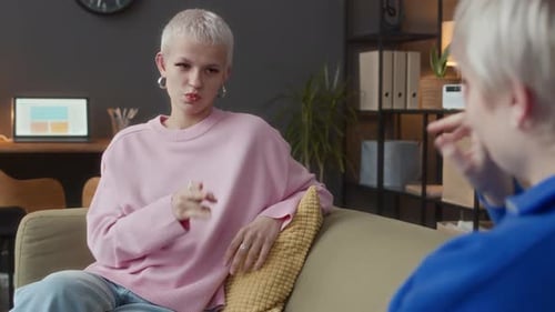 People Having a Conversation on a Sofa