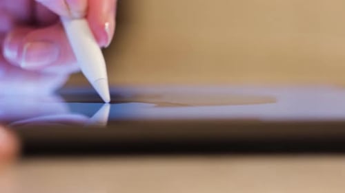 Hand Using Stylus on Tablet Screen Close Up