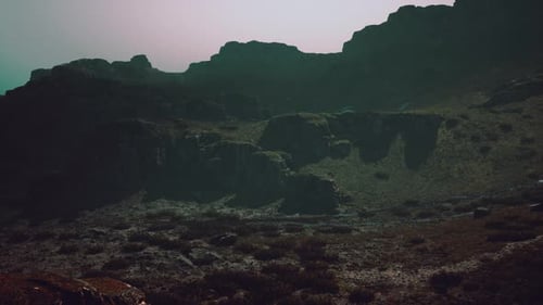 A Large Mountain with a Few Rocks on Top of It