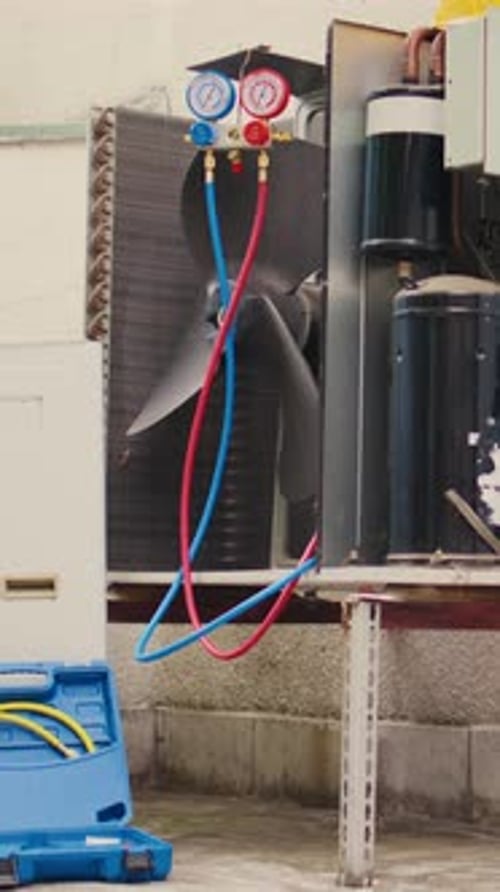 HVAC System Being Serviced with Gauges and ToolBox