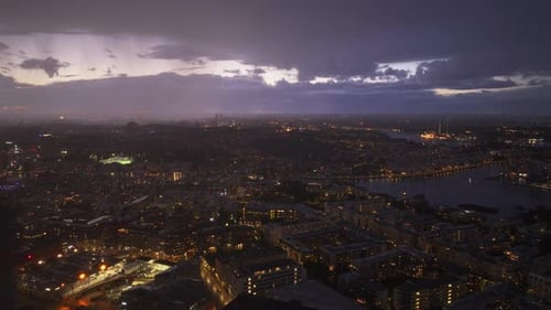 Stockholm City Lights Glitter Under a Dramatic Lightning Storm Purple Sky Reflects in the Water