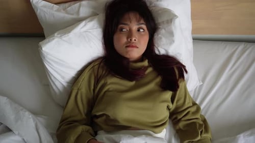 Woman Waking Up and Stretching in Bed