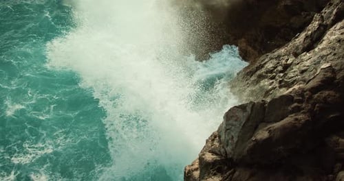 Ocean Waves Shooting Up Through a Crevasse in the Rock Slowmotion Sea Water Foaming and Splashing
