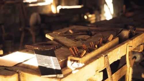 Craftsman Workshop Filled with Tools and Wooden Materials During Daylight Hours