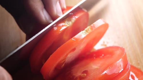 Tomato Slicing Close-Up on Wooden Cutting Board