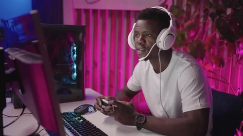 Man Playing Video Games at Home at Night