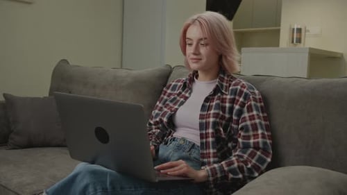 Woman Celebrating Success While Working on Laptop