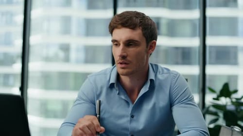 Portrait of Responsible Office Manager Working in Company Skyscraper Sitting Workplace. Handsome