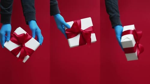 Gift Presentation with Gloves on Red Background