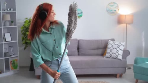 Woman Dancing with Mop While Cleaning Home