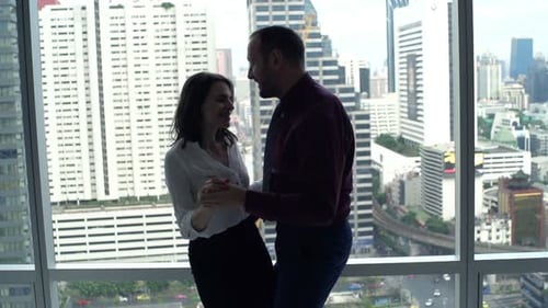 Couple Dancing Together Next to the Office Window