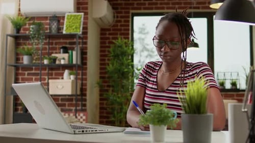 Young Woman Working at Desk with Laptop
