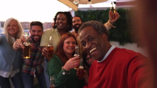 Group of Friends Celebrating with Beer on Rooftop