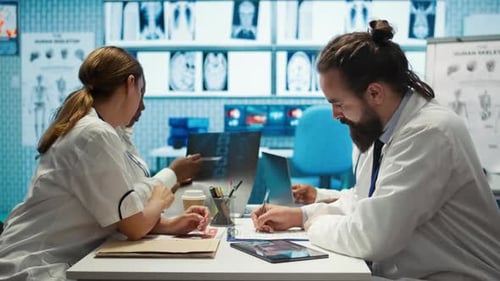 Medical Team Analyzing X-rays in Office