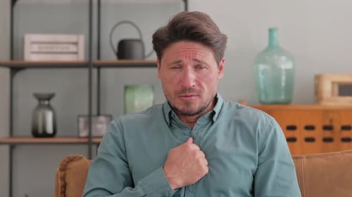 Portrait of Coughing Casual Man at Home