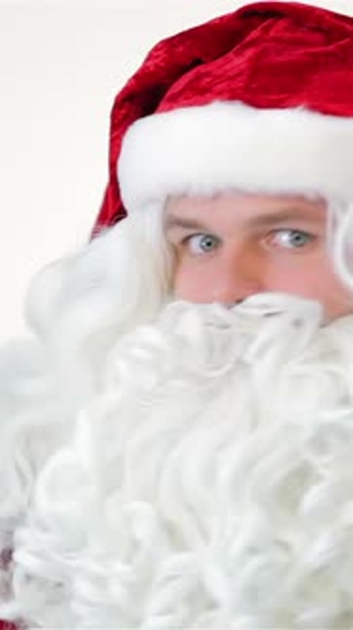 Man in Santa outfit looks curiously side to side