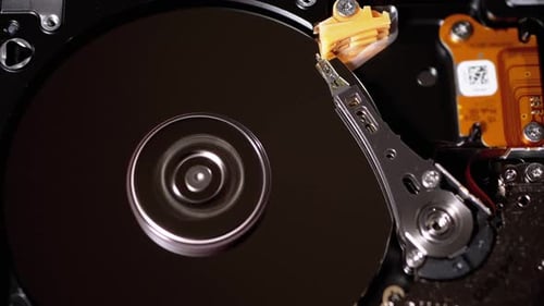 Opened Hard Disk Drive with Spinning Platter