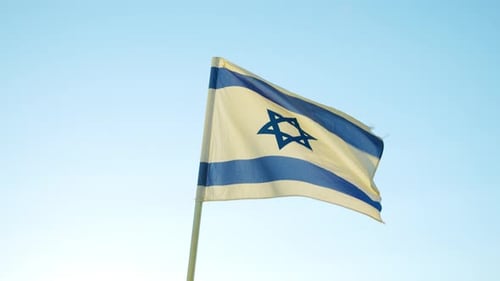 Israeli Flag Waving Against a Clear Blue Sky