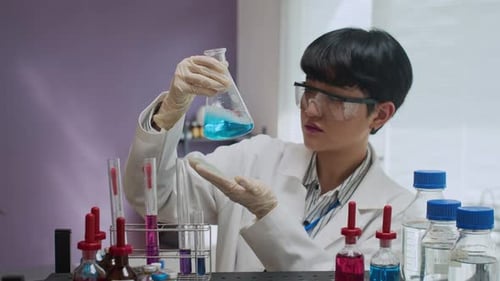Scientist Performing Chemistry Experiment in the Lab