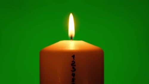 Candle with Advent Calendar on Green Chroma Key Background Traditional Burning Christmas Wax Candles