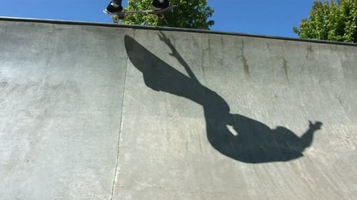 Shadow of Skateboarder Sliding Concrete Quarter Pipe 18-19