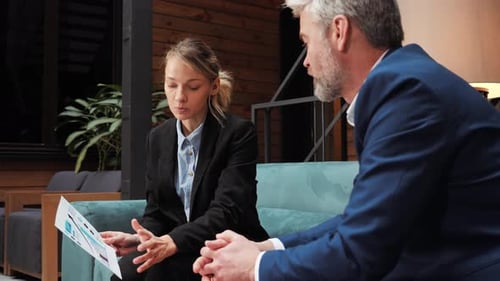 Business People Discussing Charts at Office Meeting