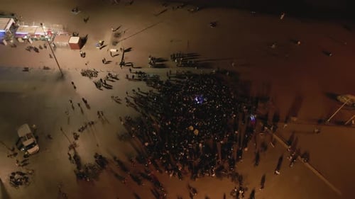 Aerial Drone Shot Above Crowd at Openair Concert at Night on the Coast
