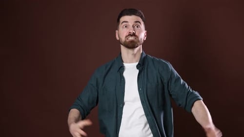 Resentment. Displeased man showing frustration on brown background