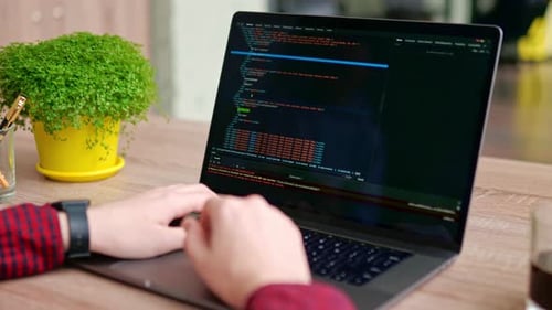 Close Up of Freelancer's Hands Typing Code on Laptop Keyboard Camera Slides Around Developer's