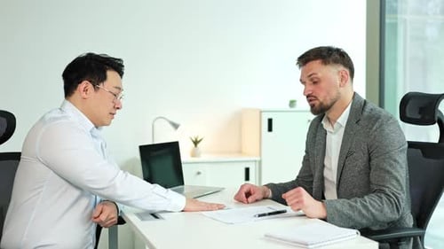 Businessmen Discussing and Making a Deal in a Modern Office