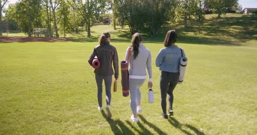 Women Friends with Yoga Mats Walking in Sunny Park 2024 Years
