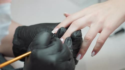 Applying Nail Polish with Brush at Beauty Salon