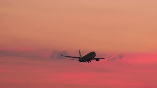Airplane Taking Off During Vibrant Sunset